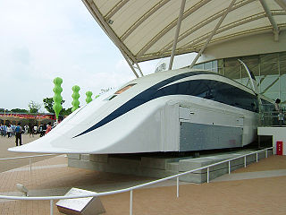 Maglev train displayed in front of building.
